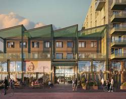 Wooncomplex in een parkachtige omgeving met meerdere gebouwen, groene gevels, wandelpaden en grasvelden waar mensen wandelen.