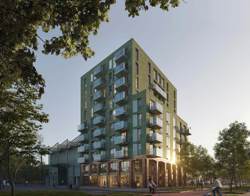 Twee woongebouwen met groene gevels en balkons, omgeven door bomen en groen, met wandelaars, fietsers en geparkeerde auto's langs de straat.